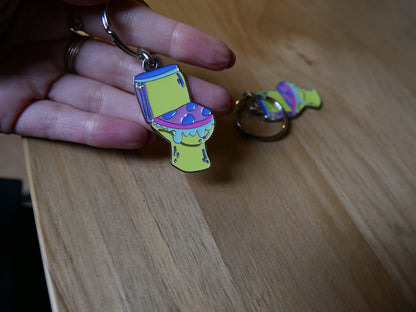 Porté-clés toilettes "Les larmes des ouin-ouins" en émail avec attache métal